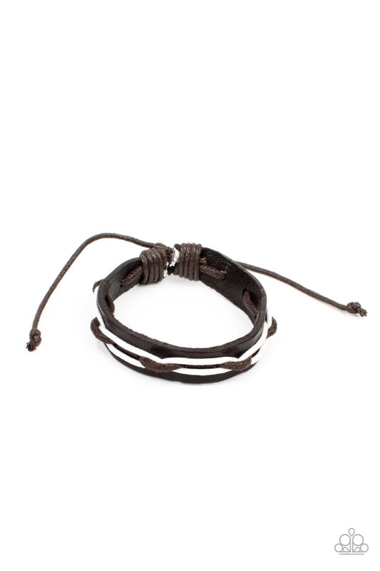 Brown and white cording is interwoven across the top of a dark brown leather band creating an edgy crisscrossed motion as it travels around the wrist. Features an adjustable sliding knot closure.  Sold as one individual bracelet.