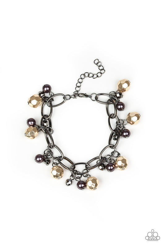 Varying in size, a collection of faceted gold and pearly gunmetal beads swings from a bold gunmetal chain, creating a whimsical metallic fringe around the wrist. Features an adjustable clasp closure.

Sold as one individual bracelet.