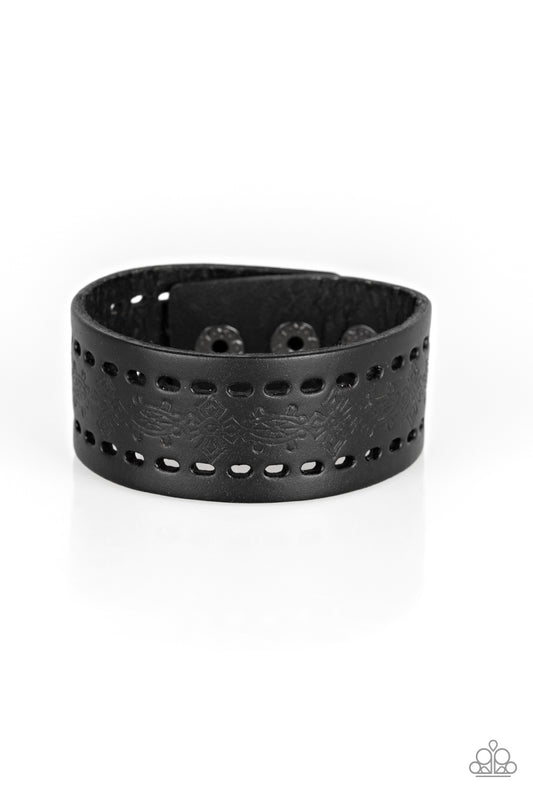 Stamped in a southwestern textile inspired pattern, a shiny black leather band wraps around the wrist for a seasonal look. Features an adjustable snap closure.  Sold as one individual bracelet.