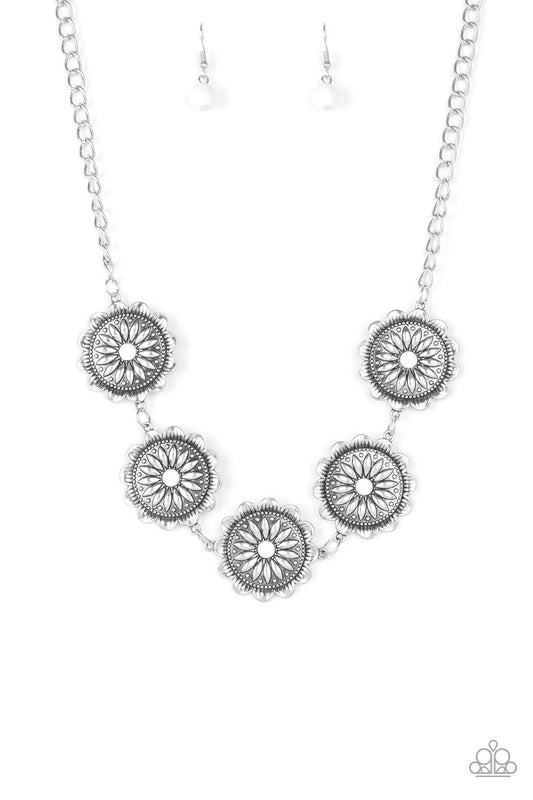 Infused with shiny white beaded centers, ornate floral stamped frames link below the collar for a colorfully, seasonal look. Features an adjustable clasp closure.  Sold as one individual necklace. Includes one pair of matching earrings.