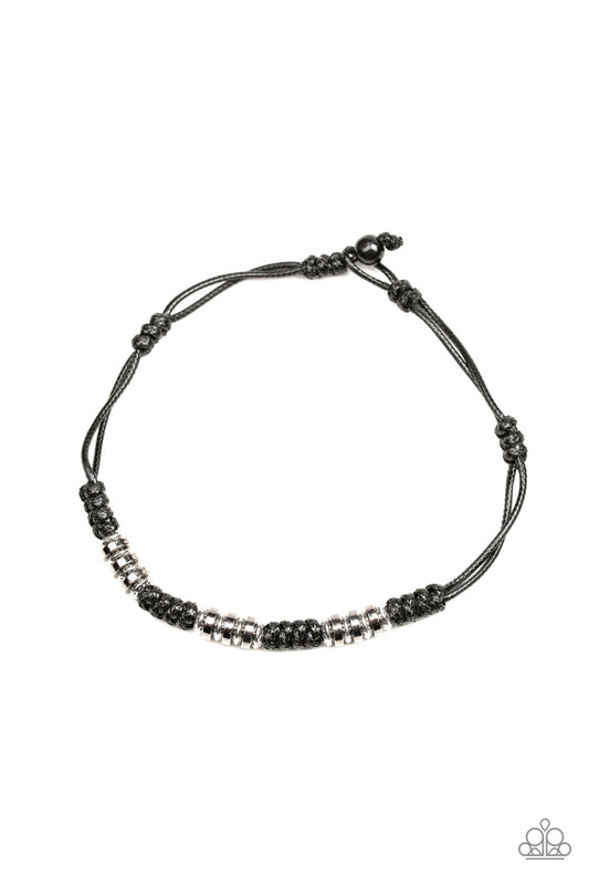 Shiny black cording knots around sections of shiny silver and gunmetal accents, creating an urban look below the collar. Features a button loop closure.  Sold as one individual necklace.
