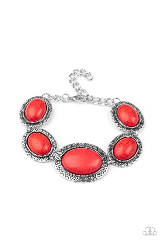 Stamped in dotted sunburst patterns, oval red stone encrusted silver frames delicately link around the wrist for a colorful southwestern flair. Features an adjustable clasp closure.  Sold as one individual bracelet.