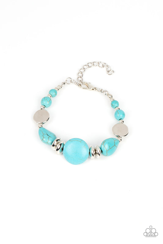 Round and teardrop turquoise stone beads join mismatched silver accents along an invisible wire around the wrist, resulting in an artisan inspired fashion. Features an adjustable clasp closure.  Sold as one individual bracelet.