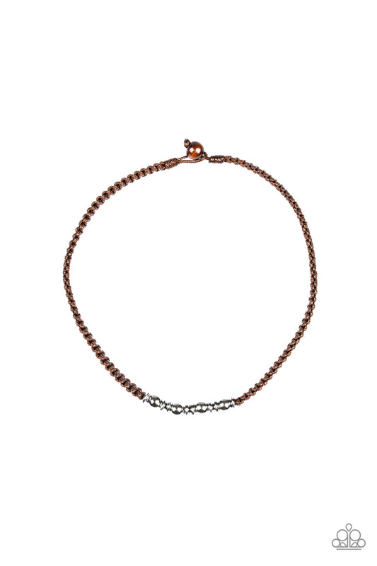 Braided cords give way to a collision of silver beaded accents, creating an urban look below the collar. Features a button-loop closure.  Sold as one individual necklace.