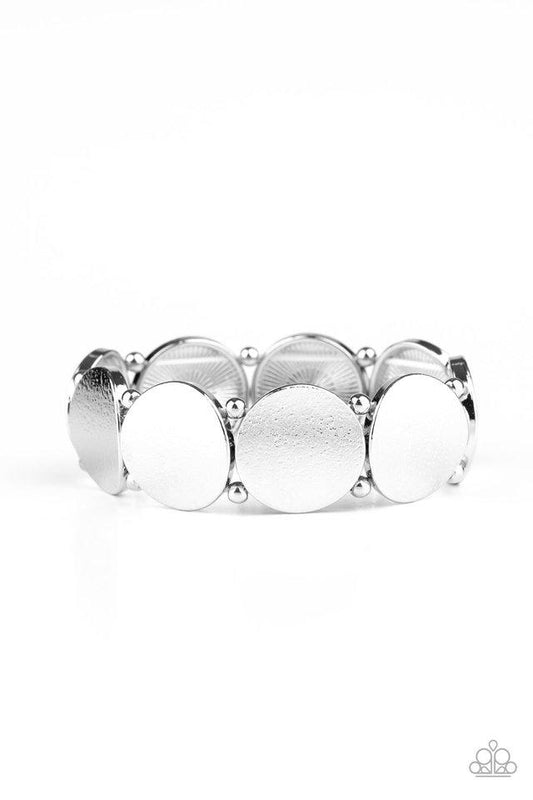 Infused with pairs of dainty silver beads, delicately hammered silver discs slide along a stretchy band around the wrist for a hint of industrial flavor.

Sold as one individual bracelet.