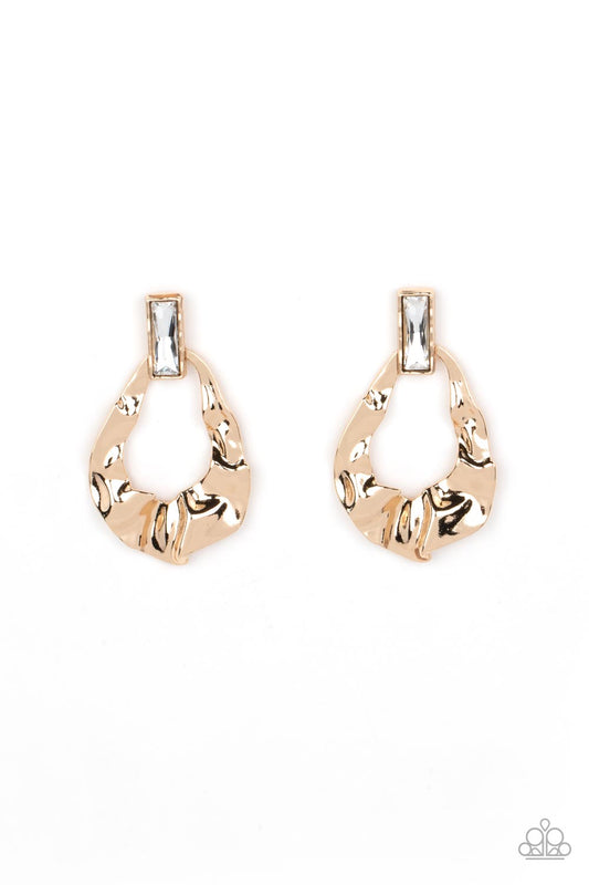 Folds of warped gold delicately gather into an edgy teardrop at the bottom of an emerald cut white rhinestone. Earring attaches to a standard post fitting.  Sold as one pair of post earrings.