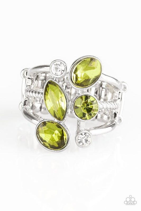 Varying shape and cut, glassy white rhinestones and glittery green rhinestones tumble down the center of layered silver bands for an edgy look. Features a stretchy band for a flexible fit.  Sold as one individual ring.