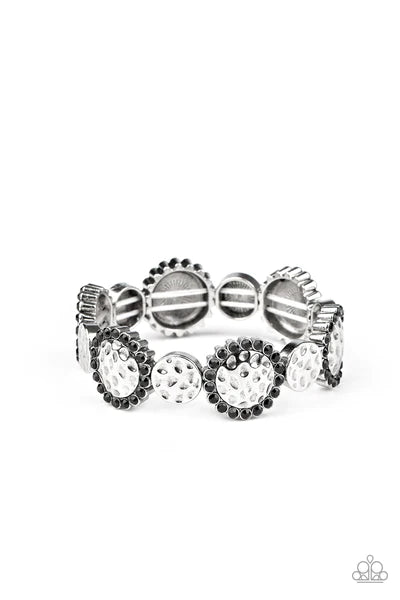 Ringed in glittery black rhinestones, hammered silver frames alternate with dainty hammered discs along stretchy bands around the wrist for a refined flair.  Sold as one individual bracelet.