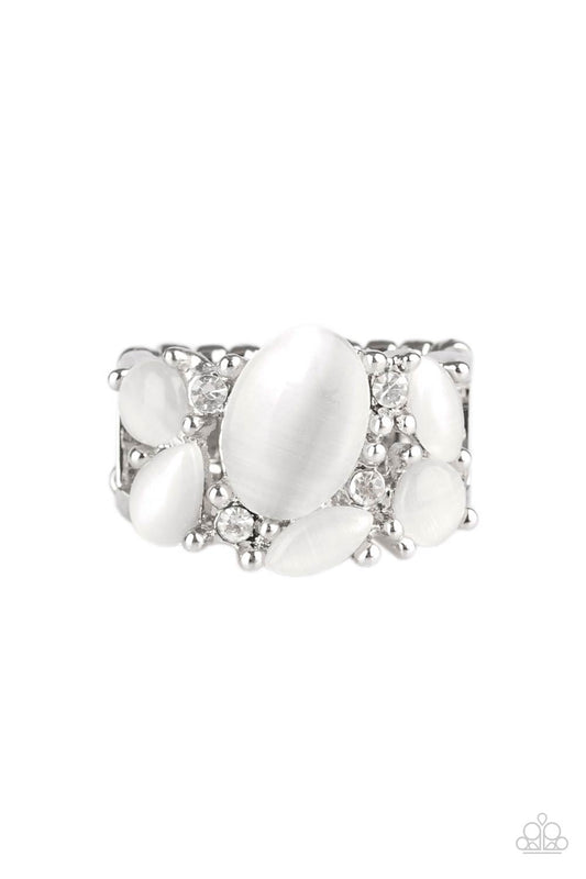 Glittery white rhinestones and glowing white moonstones are sprinkled across the finger, coalescing into a whimsical band. Features a stretchy band for a flexible fit.  Sold as one individual ring.