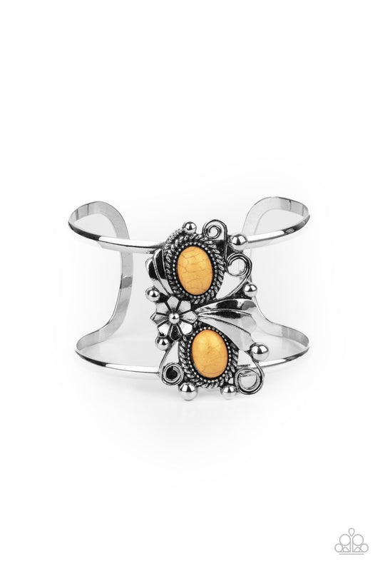 A leafy silver flower blooms between two oval yellow stones atop a studded and filigree filled backdrop, creating a subtly slanted centerpiece across an airy silver cuff.  Sold as one individual bracelet.
