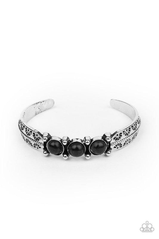 A trio of earthy black stones are encrusted along the center of a dainty silver studded cuff stamped in tribal inspired details for a seasonal flair.  Sold as one individual bracelet.