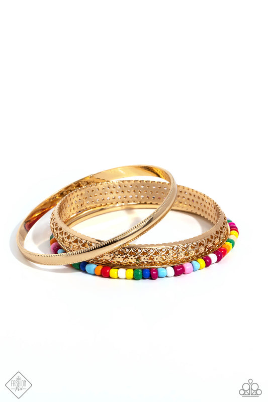 Featuring multicolored seed beads, ornate filigree, and studded texture, mismatched gold bangles stack across the wrist for a Moroccan-inspired splash of color.  Sold as one set of three bracelets.
