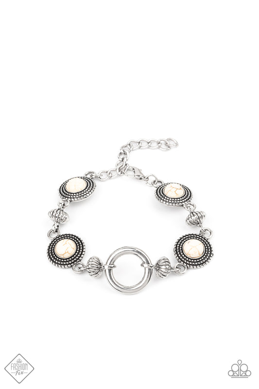 Featuring an airy silver hoop centerpiece, a rustic collection of silver beads and silver discs dotted in white stones delicately link around the wrist for a seasonal look. Features an adjustable clasp closure.  Sold as one individual bracelet.