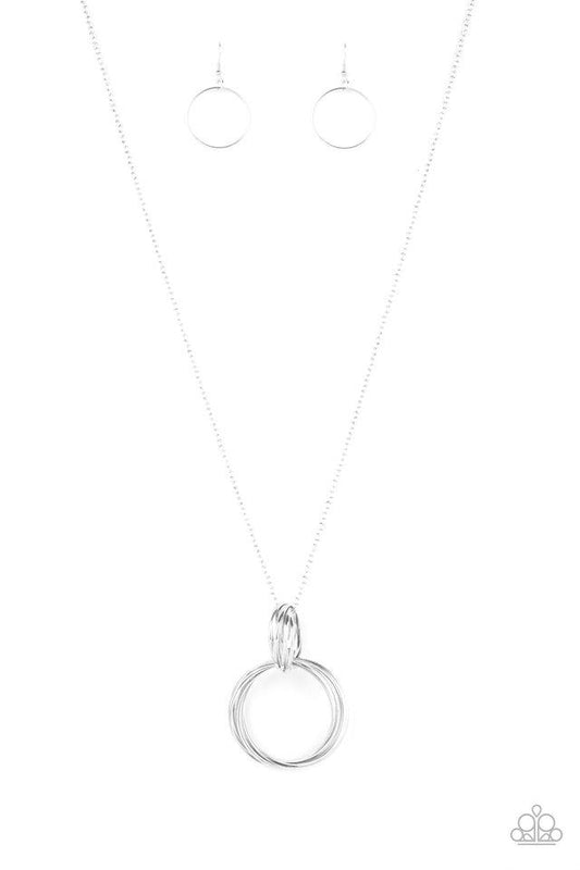 A collection of large and small shiny silver rings interlock into a bold pendant at the bottom of a lengthened silver chain. Features an adjustable clasp closure.

Sold as one individual necklace. Includes one pair of matching earrings.