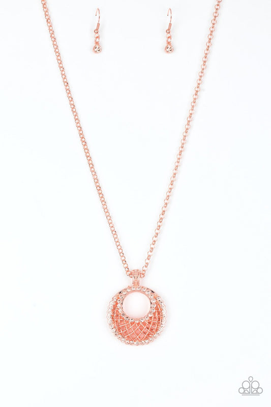 Featuring a shiny copper net-like pattern, a peach rhinestone encrusted crescent shaped frame swings from the bottom of a lengthened shiny copper chain, creating a refined 3-dimensional pendant. Features an adjustable clasp closure.  Sold as one individual necklace. Includes one pair of matching earrings.