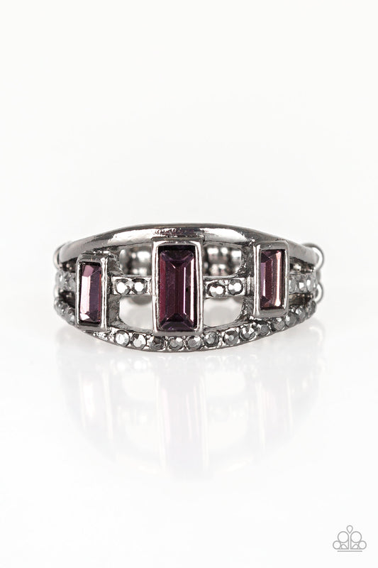Three purple emerald-cut rhinestones are encrusted along three gunmetal bands radiating with smooth surfaces and sections of glittery hematite rhinestones for an edgy fashion. Features a stretchy band for a flexible fit.  Sold as one individual ring.