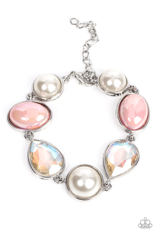 A collection of classic white pearls, iridescent Pale Rosette beads, and iridescent crystal-like teardrops wrap around the wrist in an ethereal display. Shiny silver frames encase each bead, adding a romantic vibe to the vintage inspired design. Features an adjustable clasp closure.  Sold as one individual bracelet.