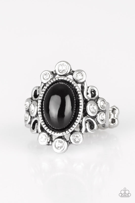 A polished black bead is pressed into a bubbly silver frame radiating with glassy white rhinestones for a notable finish. Features a stretchy band for a flexible fit.  Sold as one individual ring.