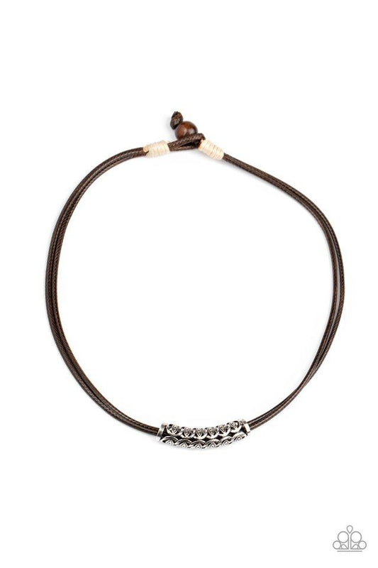 A decorative silver bar glides along shiny brown cording below the collar for a beach inspired look. Features an adjustable sliding knot closure.  Sold as one individual necklace.