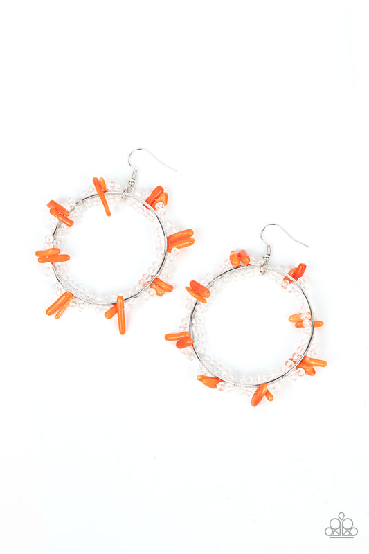 Dainty crystal-like beads and orange shell-like pieces are threaded along dainty wires, creating glitzy loops around an oversized silver ring for a beach inspired fashion. Earring attaches to a standard fishhook fitting.  Sold as one pair of earrings.