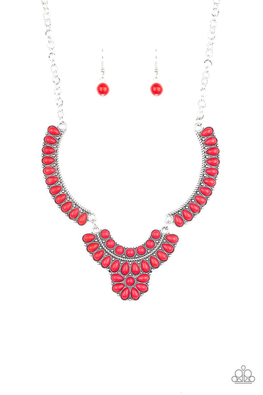Featuring round and teardrop shapes, a collection of tranquil red stone beads are pressed into interconnected silver plates, creating a fiery floral inspired statement piece below the collar. Features an adjustable clasp closure.  Sold as one individual necklace. Includes one pair of matching earrings.