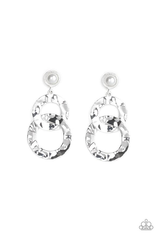 Hammered silver rings link at the bottom of a solitaire white pearl dotted frame for a refined edge. Earring attaches to a standard post fitting.  Sold as one pair of post earrings.
