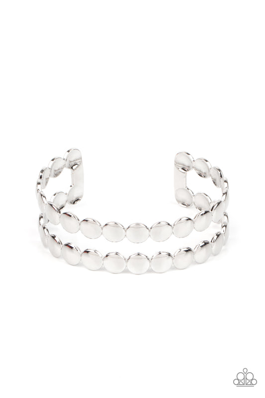 Brushed in a shiny finish, rows of flattened silver studs coalesce into a shimmery cuff around the wrist.  Sold as one individual bracelet.