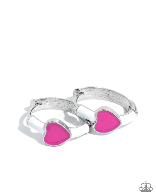 Connected to a silver hinge hoop, a strip of white paint curls towards the front of the ear, proudly displaying the Pink Peacock-painted dainty heart at its center for a romantic statement. Earring attaches to a standard hinge closure fitting. Hoop measures approximately 1/2" in diameter.