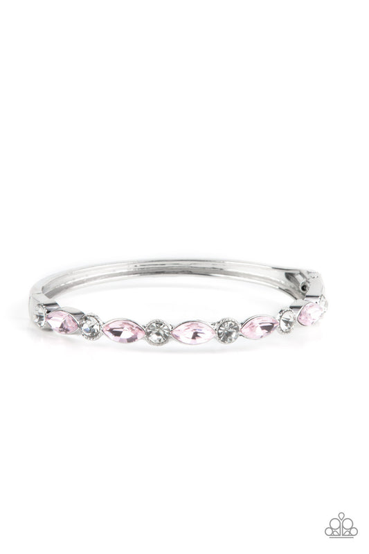 A sparkly collection of round white rhinestones and marquise pink rhinestones alternate across the top of the wrist, coalescing into a stackable bangle-like bracelet. Features a hinged closure.  Sold as one individual bracelet.