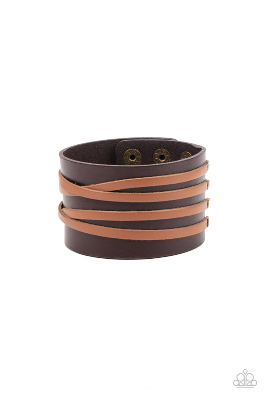 Crisscrossing tan leather strands are studded in place across the front of a thick brown leather band, creating a rugged centerpiece. Features an adjustable snap closure.  Sold as one individual bracelet.