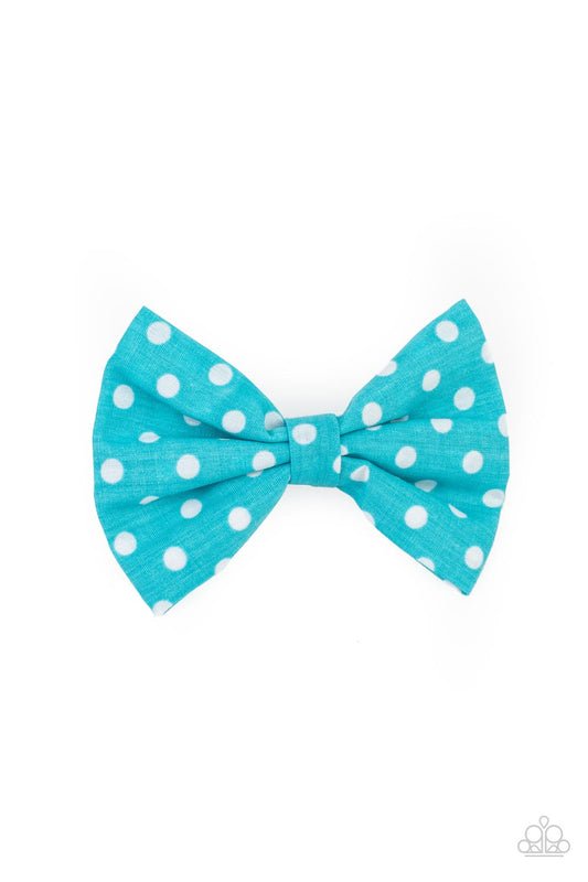 Delightful blue polka-dotted cotton fabric delicately knots into a dainty bow. Features a standard hair clip on the back.  Sold as one individual hair clip.