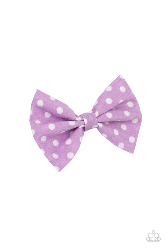 Delightful purple polka-dotted cotton fabric delicately knots into a dainty bow. Features a standard hair clip on the back.  Sold as one individual hair clip.