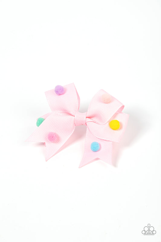 Dainty multicolored pom poms dot the front of a ribbed Pale Rosette ribbon that neatly knots into a charming bow, creating a whimsical centerpiece. Features a standard hair clip on the back.  Sold as one individual hair clip.