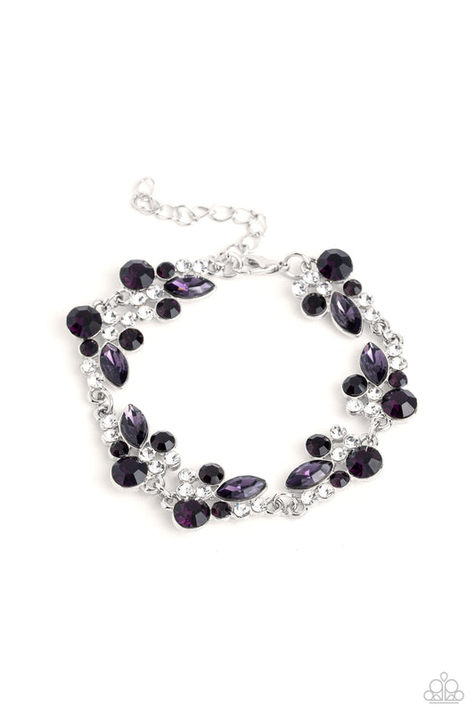 An eclectic collection of white and amethyst round rhinestones in varying sizes and marquise-cut gems in a shade of purple cluster around the wrist in high-sheen silver frames. Patterned in an abstract manner, the clusters interlock together, emitting light from every faceted angle. Features an adjustable clasp closure.  Sold as one individual bracelet.