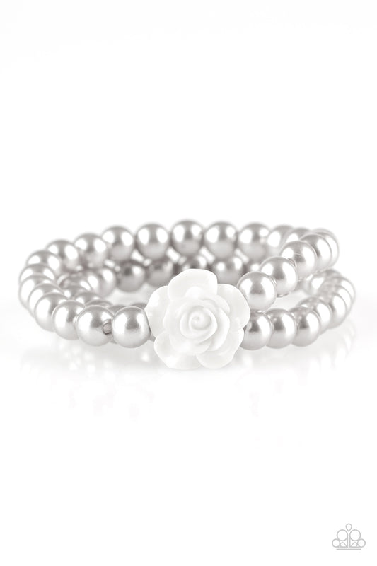 Connected by a flirty white resin rose, classic silver pearls are threaded along stretchy bands around the wrist for a vintage inspired fashion.

Sold as one individual bracelet.