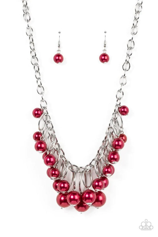 Oversized red pearls dance from the bottoms of shiny silver ovals that delicately cluster along a chunky silver chain, resulting in a luxurious fringe below the collar. Features an adjustable clasp closure.  Sold as one individual necklace. Includes one pair of matching earrings.