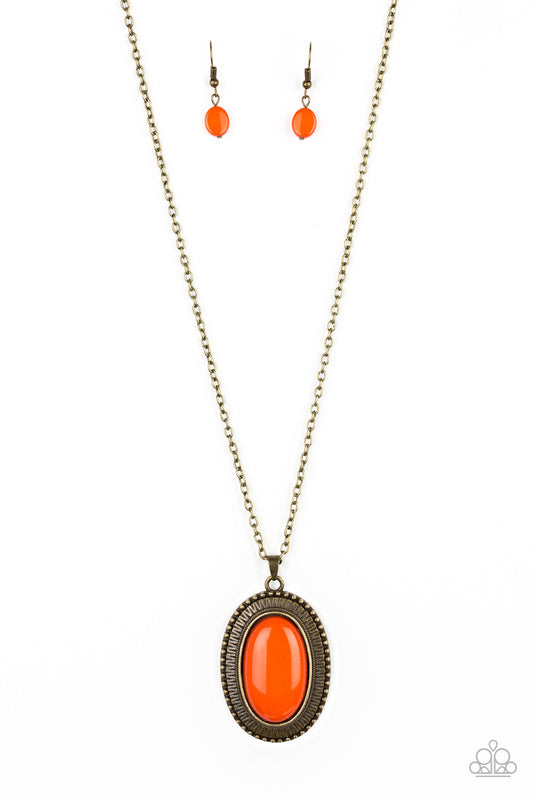 Brushed in a faux rock polish, a shiny orange bead is pressed into an ornate brass frame for a seasonal look. Features an adjustable clasp closure.  Sold as one individual necklace. Includes one pair of matching earrings.