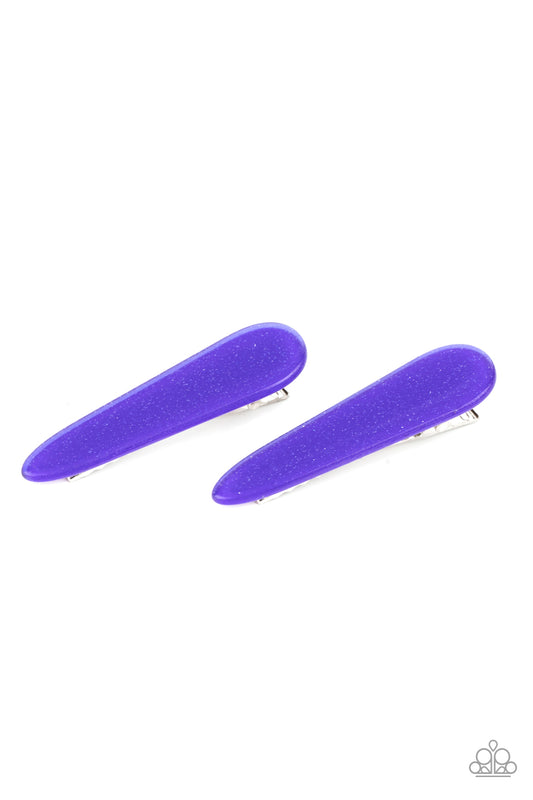 Dusted in blue glitter, a dainty pair of sparkly acrylic frames pull back the hair for a patriotic pop of color. Features standard hair clips on the back.  Sold as one pair of hair clips.