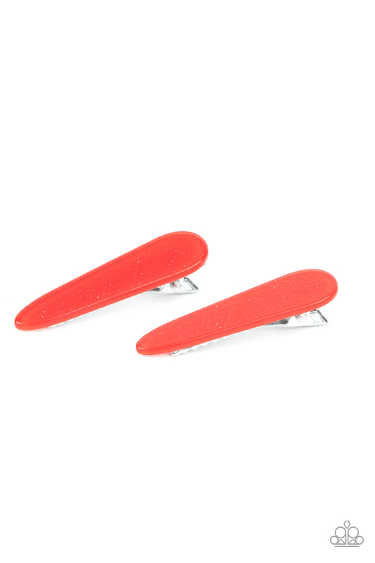 Dusted in red glitter, a dainty pair of sparkly acrylic frames pull back the hair for a patriotic pop of color. Features standard hair clips on the back.  Sold as one pair of hair clips.