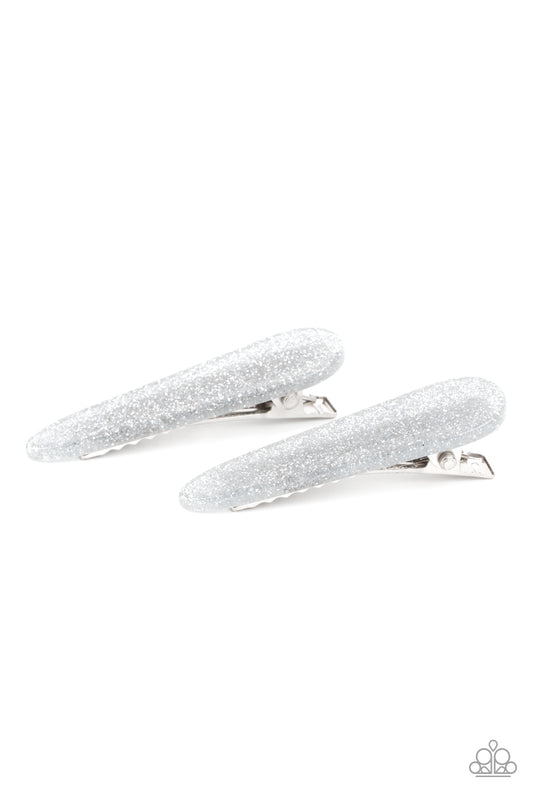 Dusted in silver glitter, a dainty pair of sparkly acrylic frames pull back the hair for a patriotic pop of color. Features standard hair clips on the back.  Sold as one pair of hair clips.