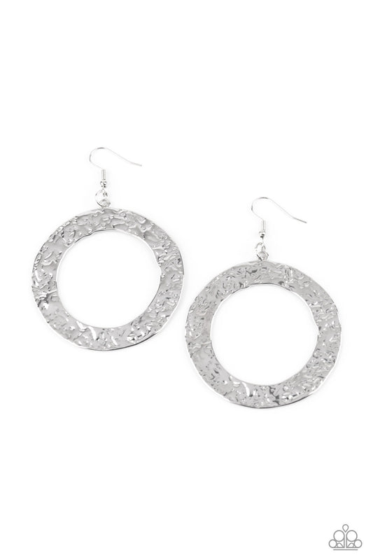 Brushed in a rustic silver finish, a flat circular frame has been hammered in blinding detail for a handcrafted look. Earring attaches to a standard fishhook fitting.

Sold as one pair of earrings.