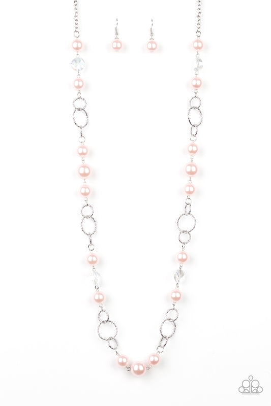 A refined collection of glassy white gems, textured silver rings, and pearly pink beads drape across the chest for a timeless look. Features an adjustable clasp closure.  Sold as one individual necklace. Includes one pair of matching earrings.