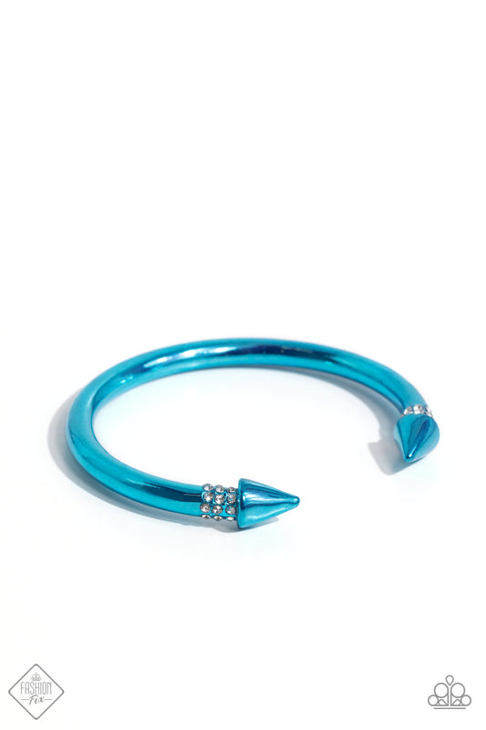 Featuring a dusting of rows of white rhinestones, a metallic blue-hued cuff with tactile spikes meeting at the center of the wrist glimmers for a seasonal look.  Sold as one individual bracelet.