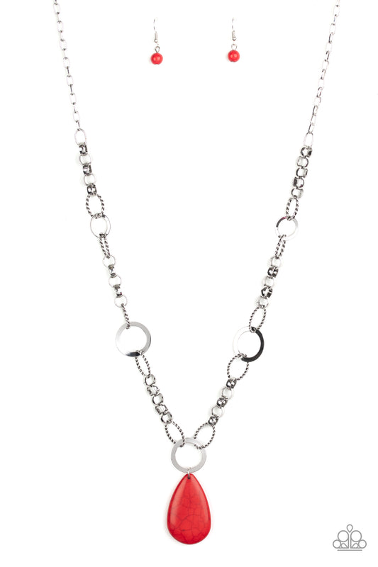 A mismatched collection of bold silver links, textured silver ovals, and flat silver rings connect down the chest, creating a unique chain. Chiseled into a tranquil teardrop, a refreshing red stone pendant swings from the bottom of the metallic compilation for an earthy finish. Features an adjustable clasp closure.  Sold as one individual necklace. Includes one pair of matching earrings.
