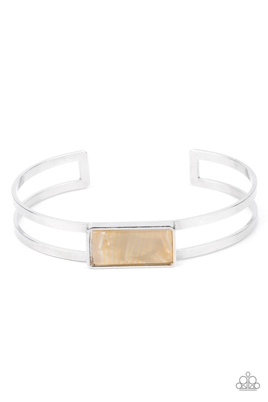 A bold shell-like acrylic accent is encased in a shiny silver rectangular frame which sits resolutely atop a double-bar silver cuff. Color and pattern may vary.  Sold as one individual bracelet.