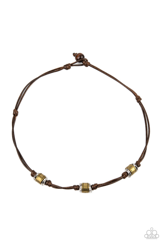 Sections of hammered silver discs and stamped brass rings are knotted in place along strands of shiny brown cording that loops around the neck for a rustic look. Features a button loop closure.  Sold as one individual necklace.