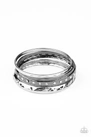 A mismatched stack of gunmetal and silver bangles are hammered in texture, creating light-catching edges that reflect an immense amount of shine. One bangle is lined with glassy white rhinestones, adding a hint of twinkle.  Sold as one set of four bracelets.