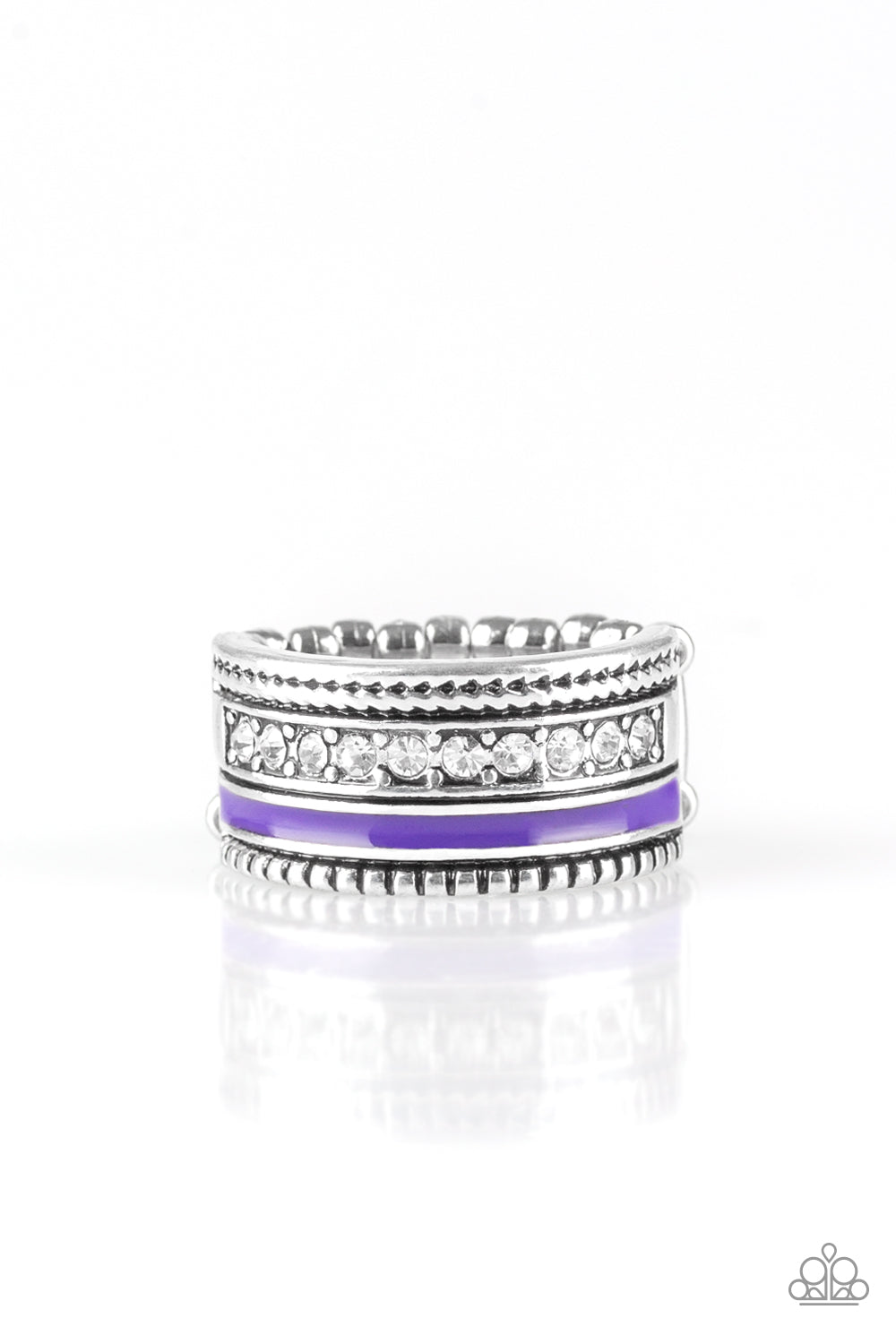 A vivacious purple strip of color runs along the bottom of a row of glassy white rhinestones. Infused with silver textures, the mismatched details coalesce into one thick band across the finger. Features a stretchy band for a flexible fit  Sold as one individual ring.