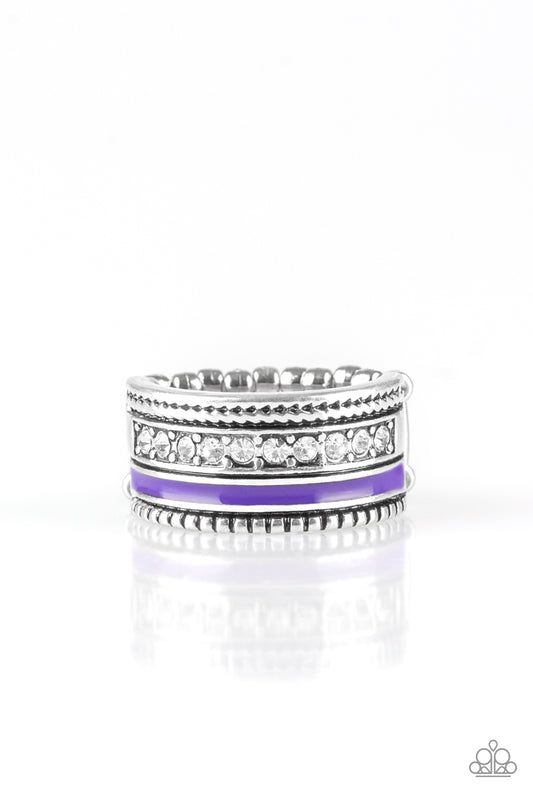 A vivacious purple strip of color runs along the bottom of a row of glassy white rhinestones. Infused with silver textures, the mismatched details coalesce into one thick band across the finger. Features a stretchy band for a flexible fit  Sold as one individual ring.