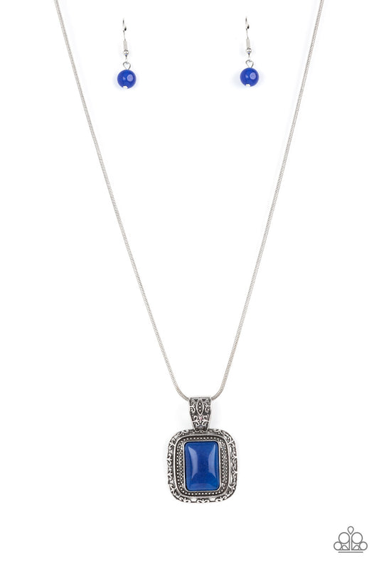A rectangular lapis lazuli stone is pressed into the center of a studded silver frame bordered in decorative filigree at the bottom of a rounded silver snake chain, creating a mystical talisman below the collar. Features an adjustable clasp closure.  Sold as one individual necklace. Includes one pair of matching earrings.